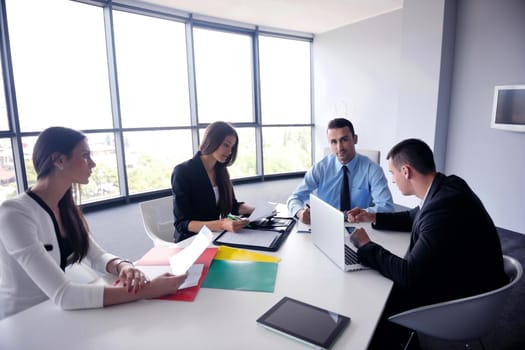 Group of happy young  business people in a meeting at office