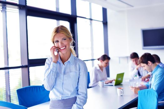 business woman  with her staff,  people group in background at modern bright office indoors