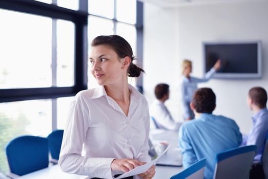 business woman  with her staff,  people group in background at modern bright office indoors