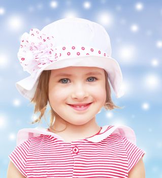 Portrait of beautiful little blond girl in a white hat with a pink bow. Close-up.