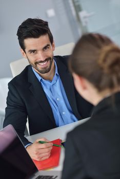 Group of happy young  business people in a meeting at office