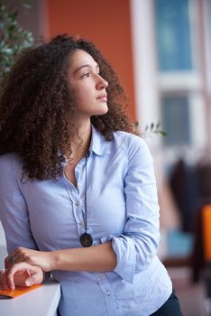 happy young  business woman with curly hairstyle in the modern office