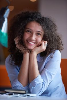 happy young  business woman with curly hairstyle in the modern office