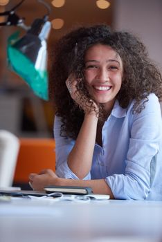 happy young  business woman with curly hairstyle in the modern office