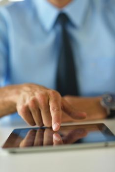 close-up of human hand  business man using tablet compuer at office