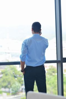 business man talking by cellphone in office