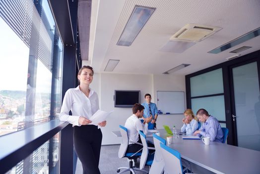 business woman  with her staff,  people group in background at modern bright office indoors