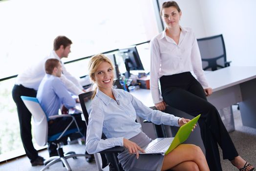 business woman  with her staff,  people group in background at modern bright office indoors