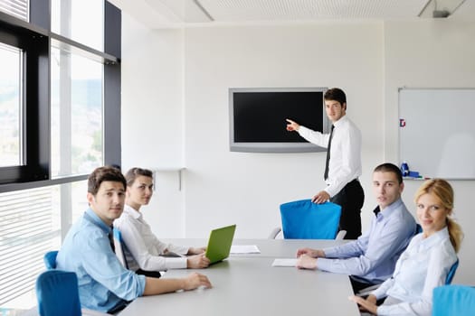 Group of happy young  business people in a meeting at office