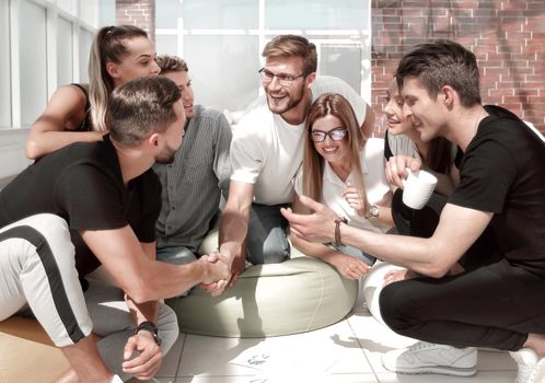 friends shaking hands when discussing a new project. the concept of a startup