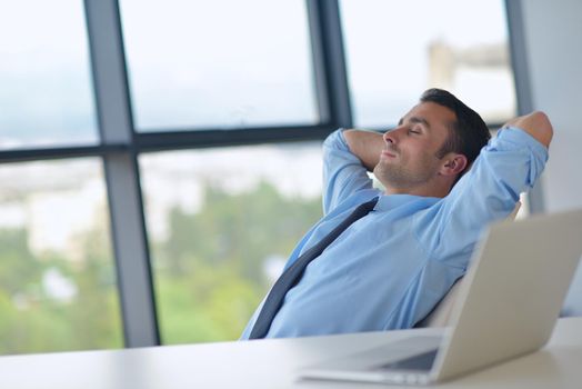 happy young business  man work in modern office on computer