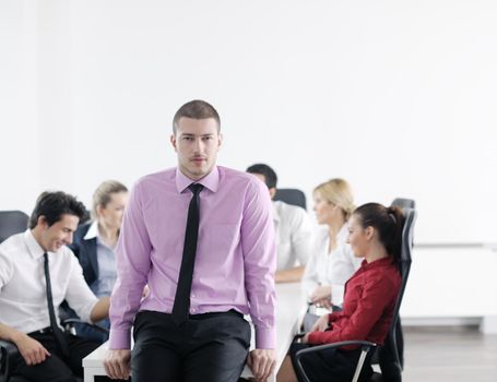 Confident young business man attending a meeting with his colleagues