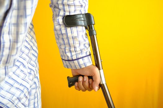 young man with broken leg on crutches
