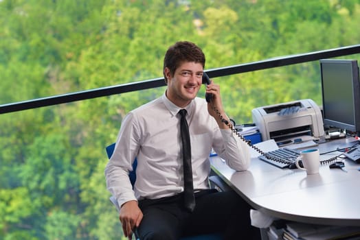 happy young business  man work in modern office on computer