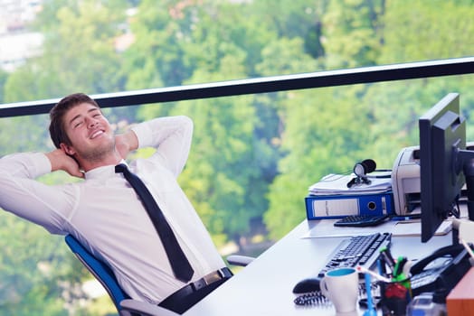 happy young business  man work in modern office on computer