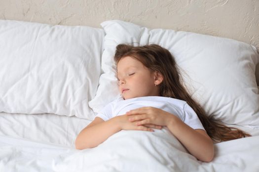 Cute child little girl sleeps in the bed