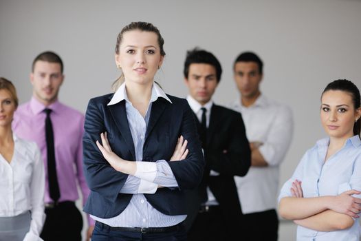 Group of young business people sitting in board room during meeting and discussing with paperwork