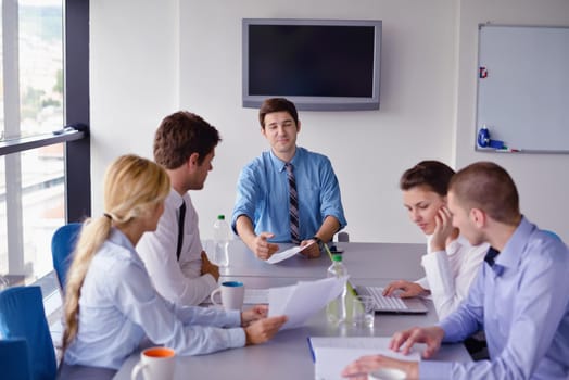 Group of happy young  business people in a meeting at office