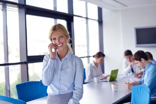 business woman  with her staff,  people group in background at modern bright office indoors