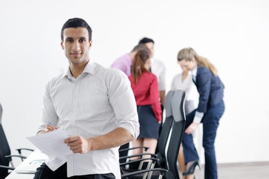 Confident young business man attending a meeting with his colleagues