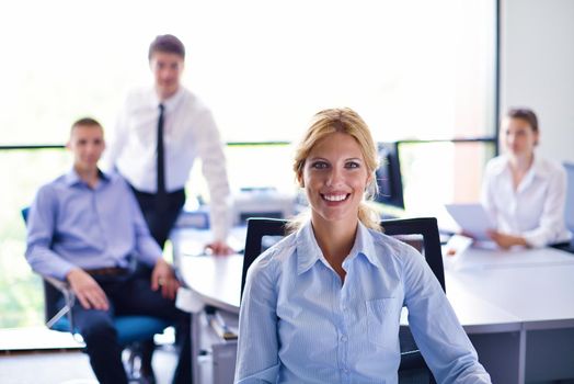 business woman  with her staff,  people group in background at modern bright office indoors