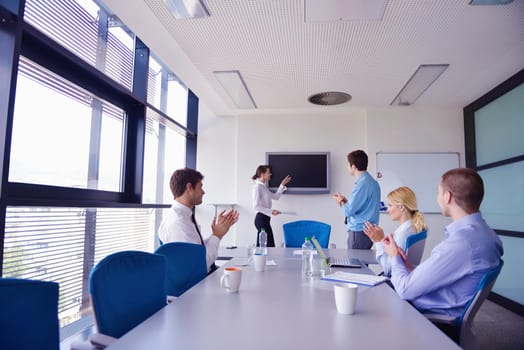 Group of happy young  business people in a meeting at office