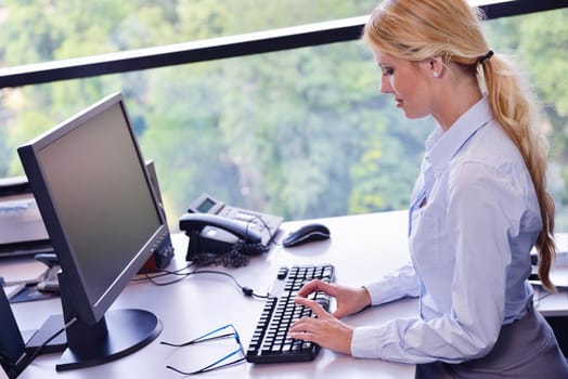 Portrait of a beautiful business woman working on her desk in an office environment.