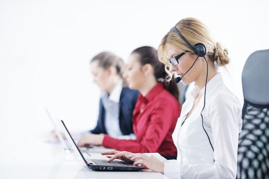 Pretty young business woman group with headphones smiling at you against white background