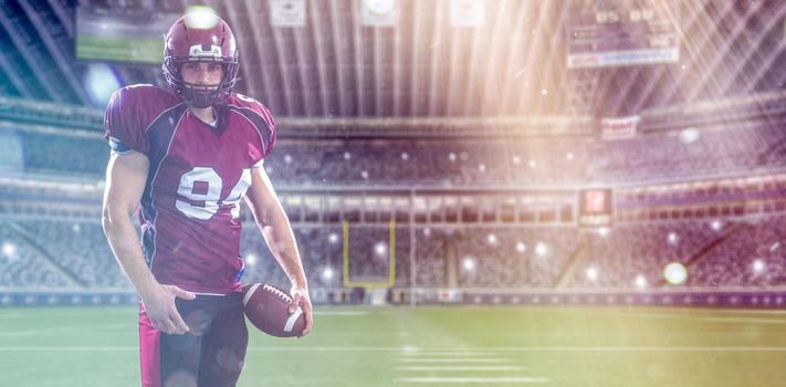 American Football Player isolated on big modern stadium field with lights and flares