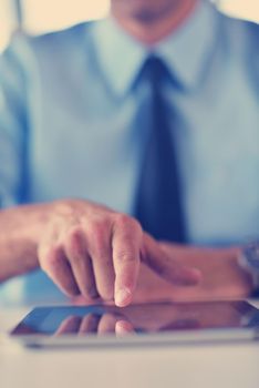 close-up of human hand  business man using tablet compuer at office