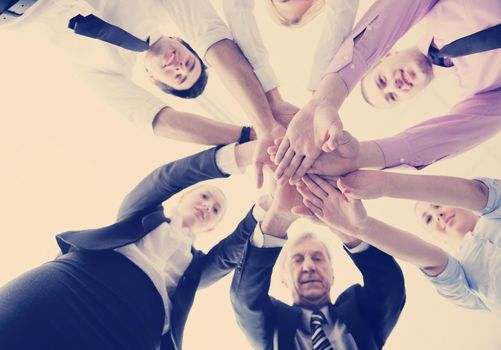 business people group joining hands and representing concept of friendship and teamwork,  low angle view