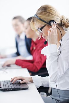 Pretty young business woman group with headphones smiling at you against white background