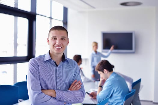 Group of happy young  business people in a meeting at office