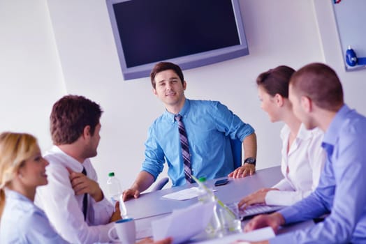 Group of happy young  business people in a meeting at office