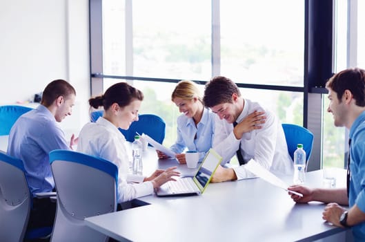 Group of happy young  business people in a meeting at office