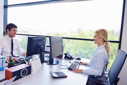 Group of happy young  business people in a meeting at office