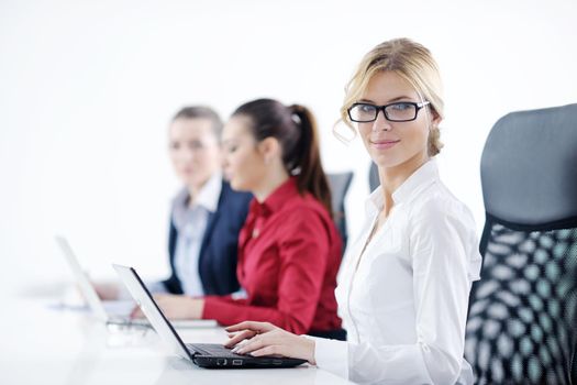 Pretty young business woman group with headphones smiling at you against white background