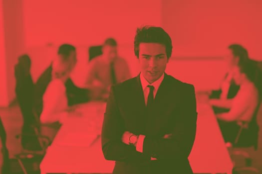 Confident young business man attending a meeting with his colleagues