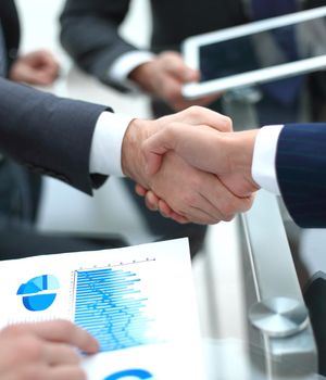 handshake business colleagues in office