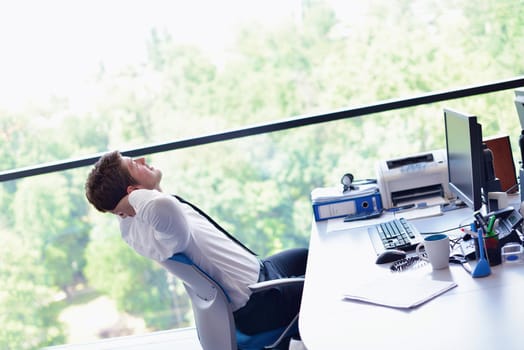 happy young business  man work in modern office on computer