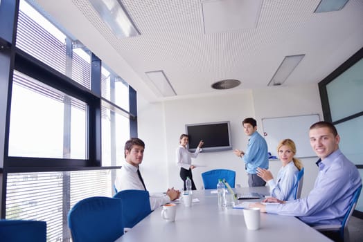 Group of happy young  business people in a meeting at office