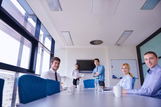 Group of happy young  business people in a meeting at office