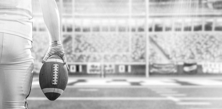 Closeup Portrait of a strong muscular American Football Player on big modern stadium field with lights and flares