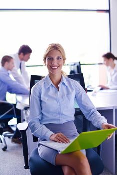 business woman  with her staff,  people group in background at modern bright office indoors