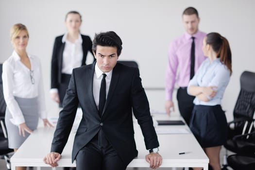 Confident young business man attending a meeting with his colleagues