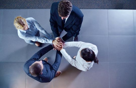 business people group joining hands and representing concept of friendship and teamwork,  low angle view