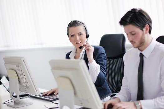 business people group with  headphones giving support in  help desk office to customers, manager giving training and education instructions