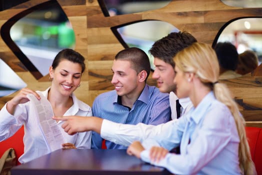 Group of happy young  business people in a meeting at office