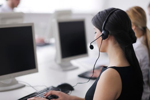 business people group with  headphones giving support in  help desk office to customers, manager giving training and education instructions