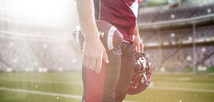 Closeup Portrait of a strong muscular American Football Player on big modern stadium field with lights and flares